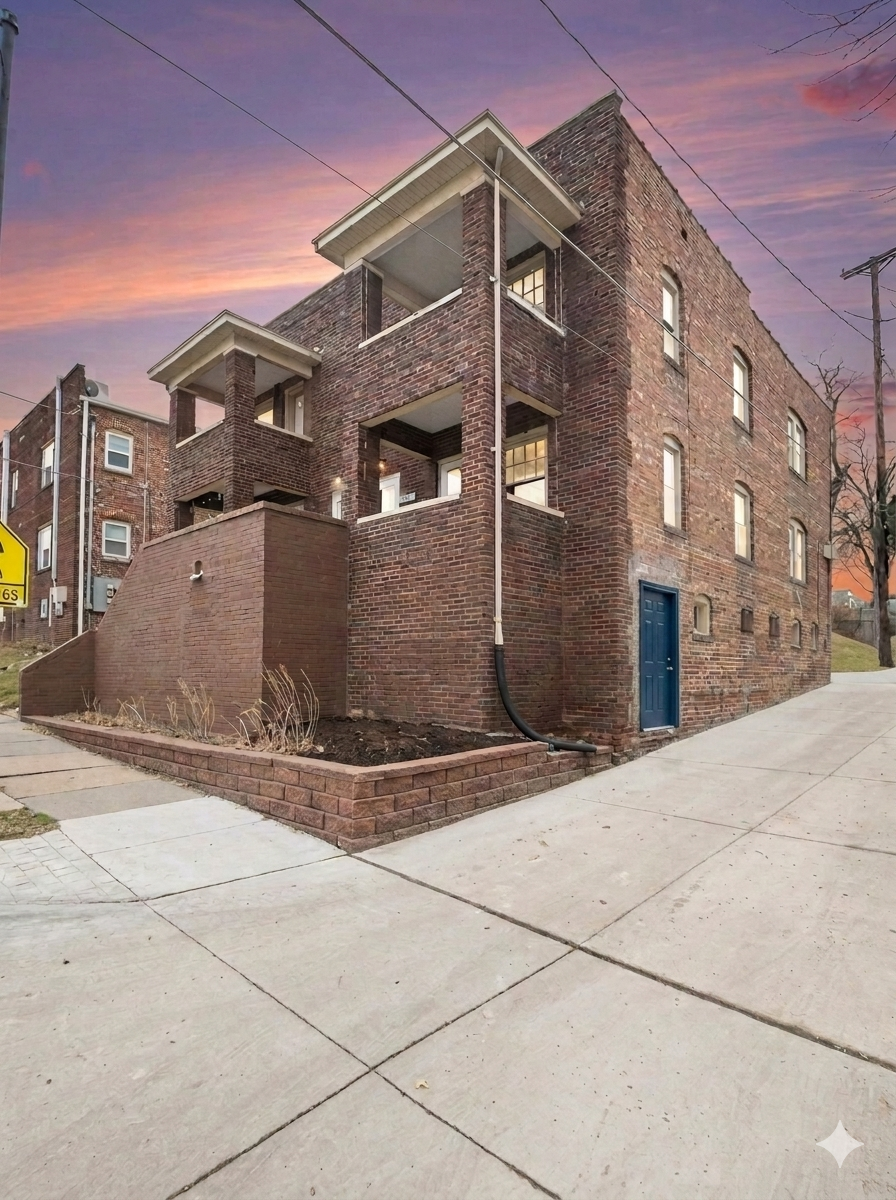 J Squared Properties building exterior at sunset